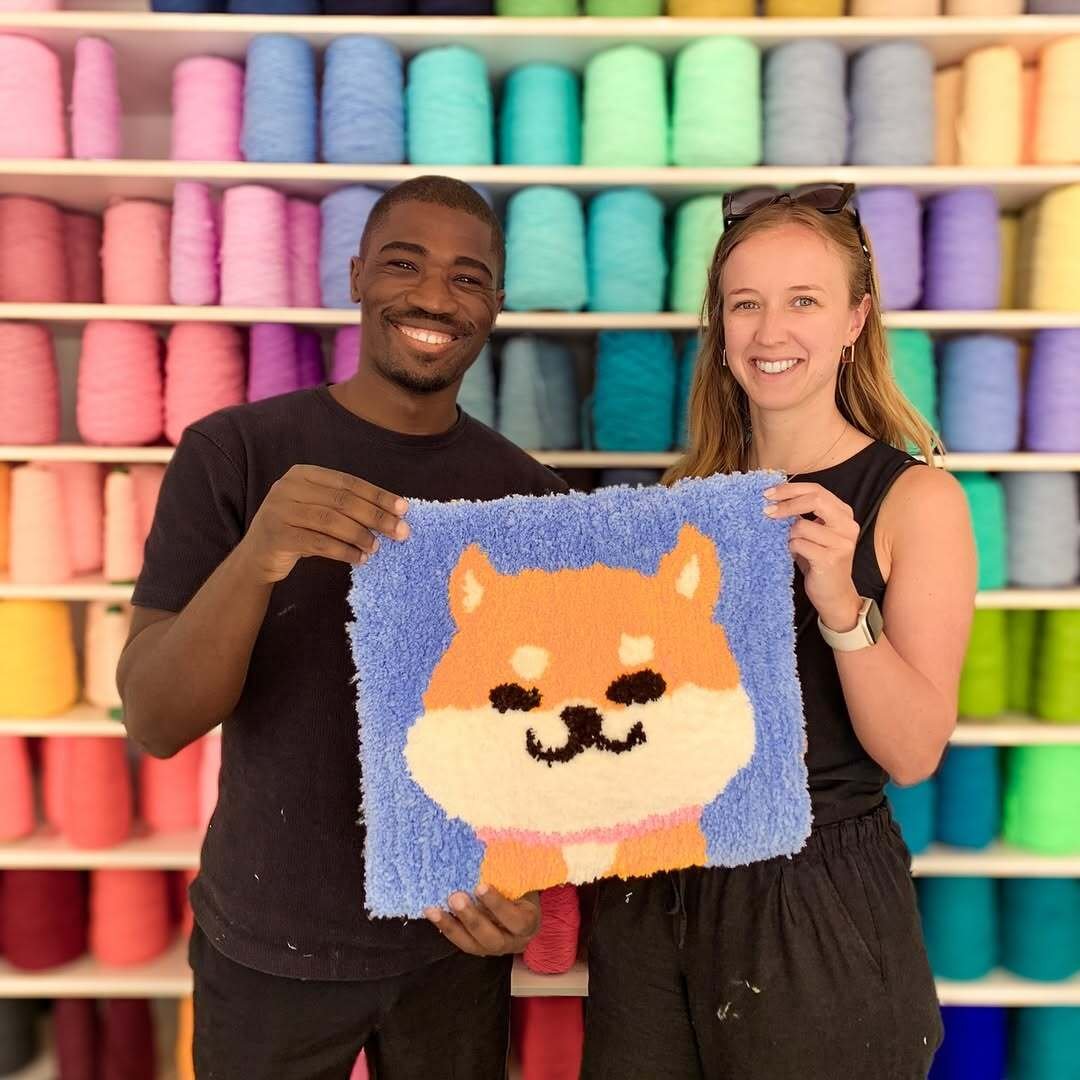 Couple holding rug at Tuft Crowd