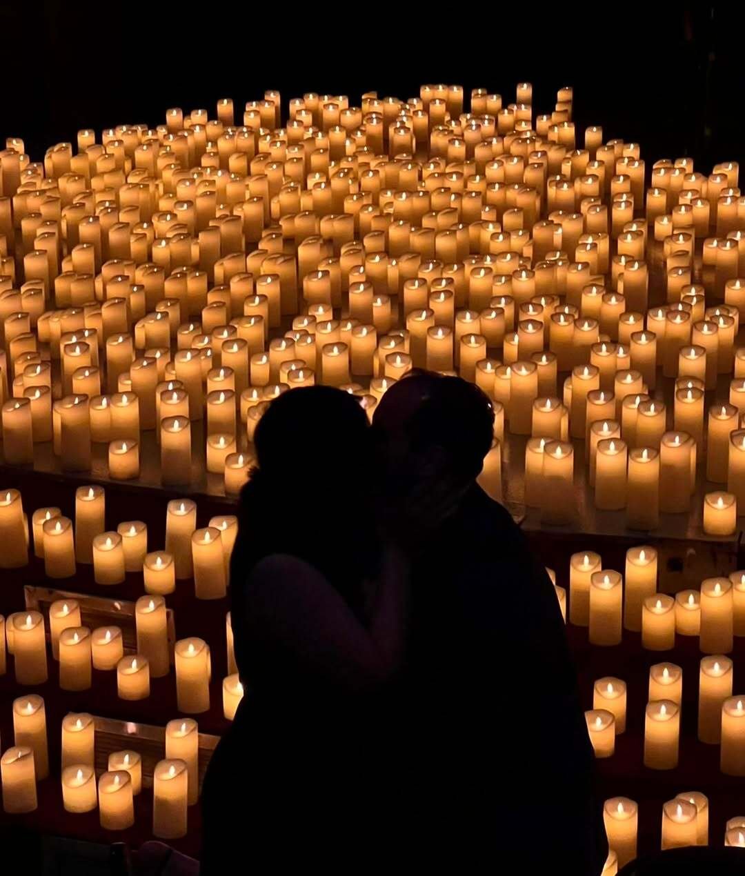 Couple kissing by candlelight