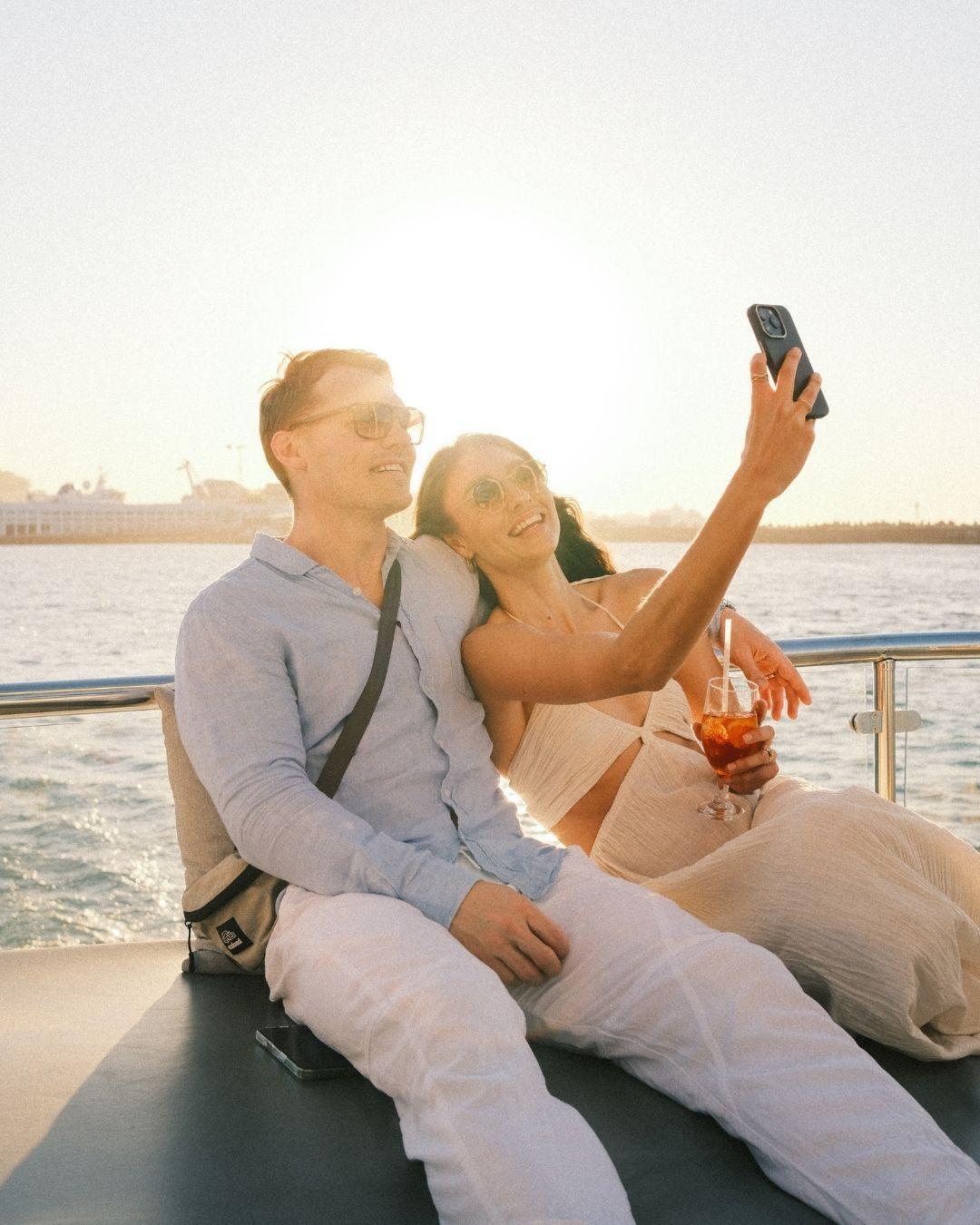 Couple taking selfie on catamaran