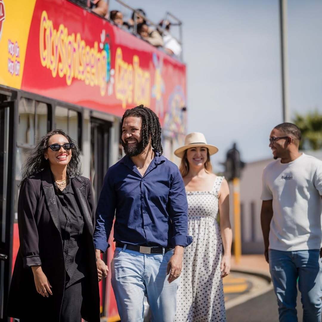 Guests hopping off the City Sightseeing Red Bus at a designated stop