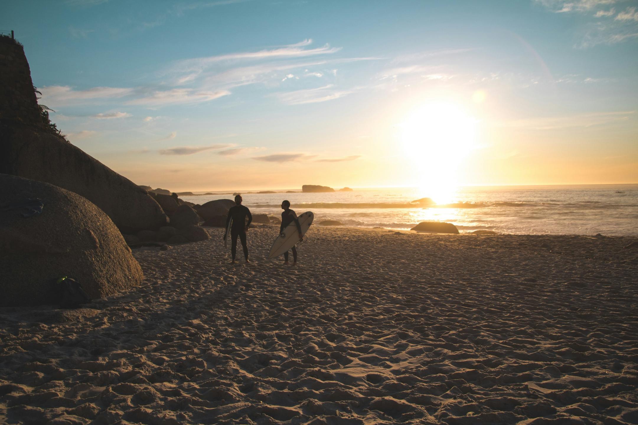 Two surfers walking on Llandudno Beach