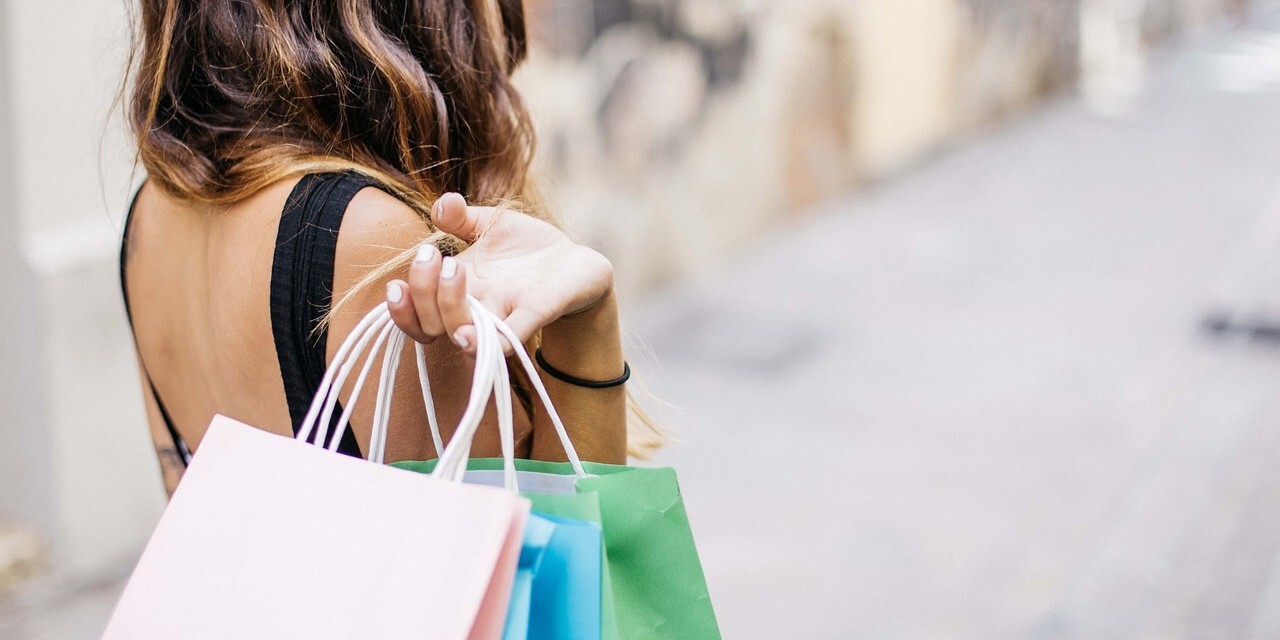 Woman carrying shopping bags over her shoulder