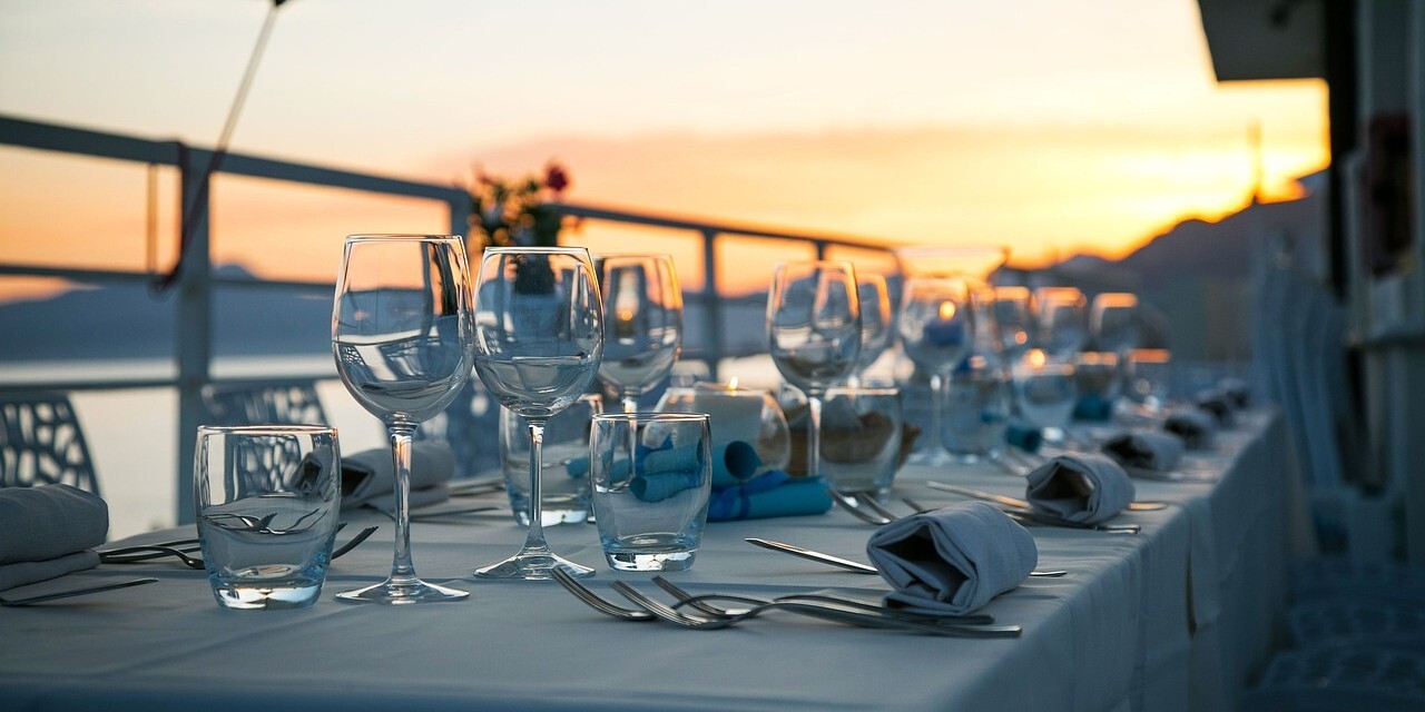 A set dining table with sunset in background