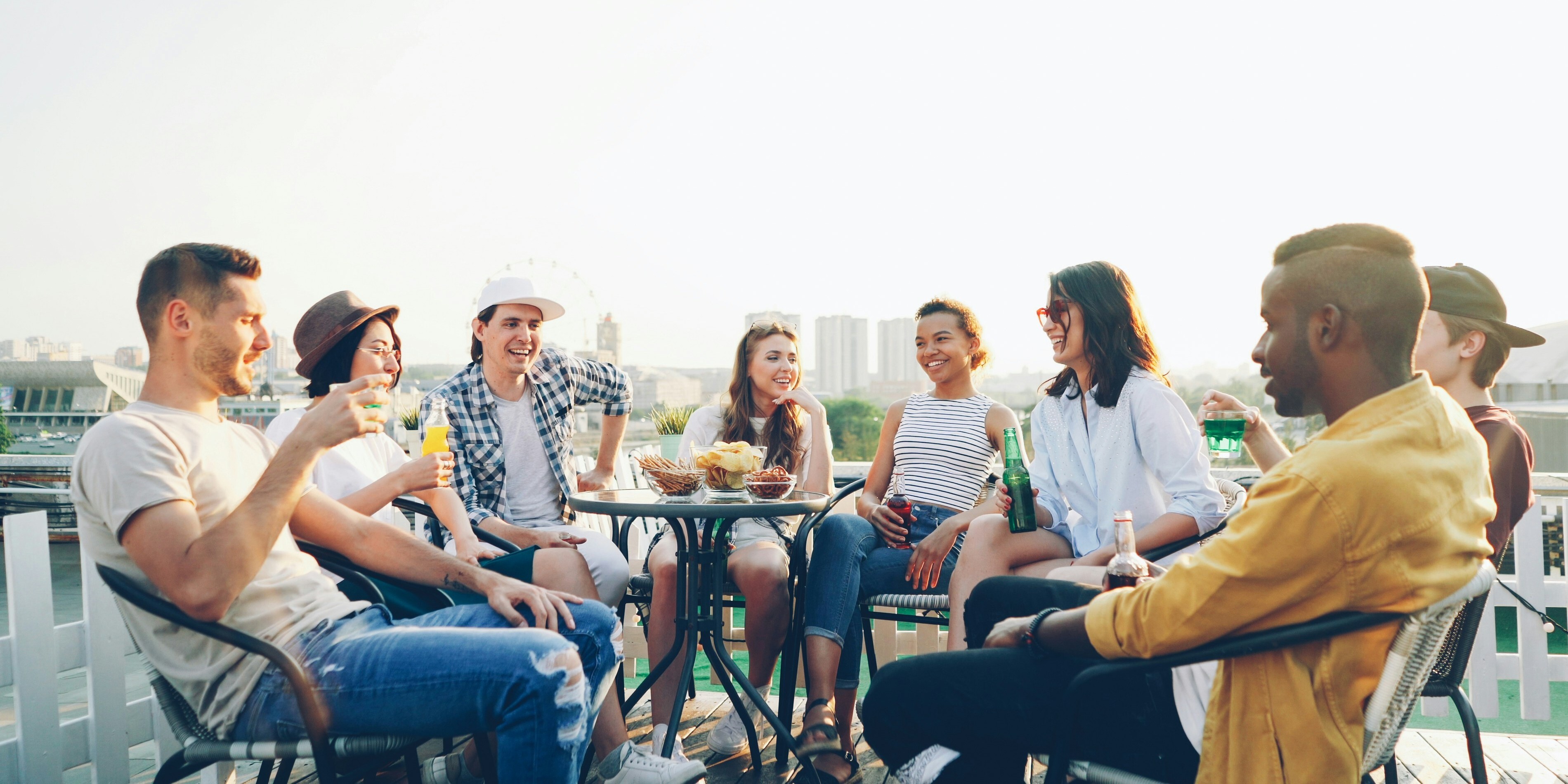 Group of friends enjoying drinks on a rooftop